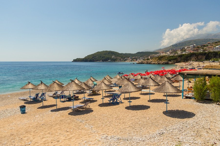 Things To Do In Himare, Albania - Sunbathers on the beach in Himare resort, Albania.
