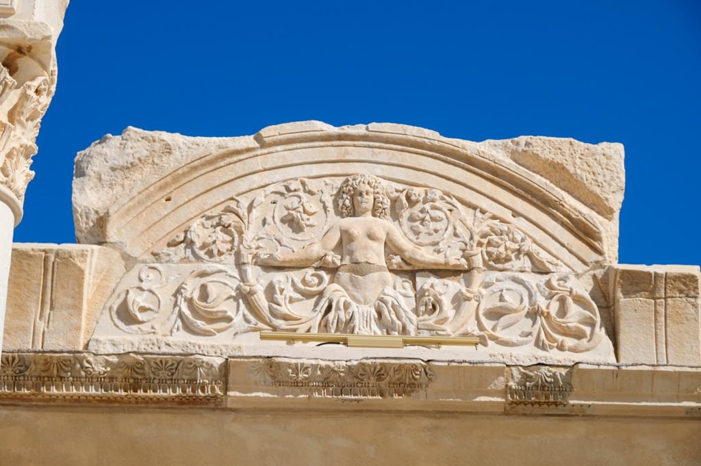 An Ephesus-inspired statue of a woman adorning the side of a building.